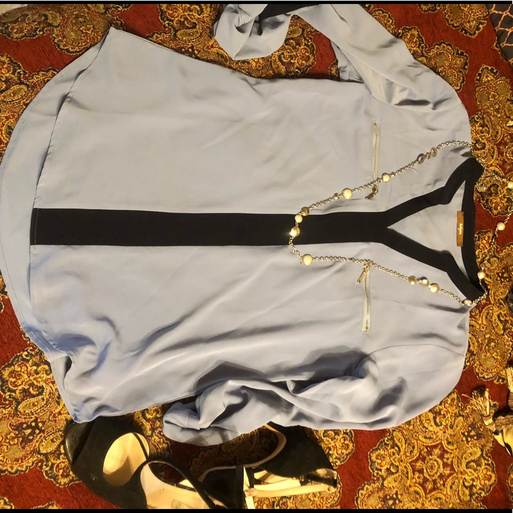 Light blue with navy accent lightweight shirt. It has rolled cuffs. Very cute